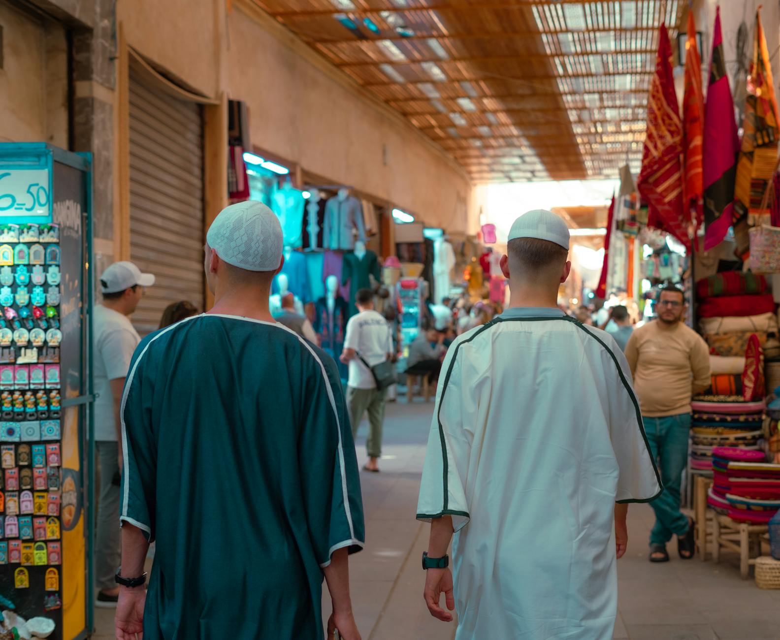 Vibrant street market in Marrakesh, capturing local culture and traditional attire.